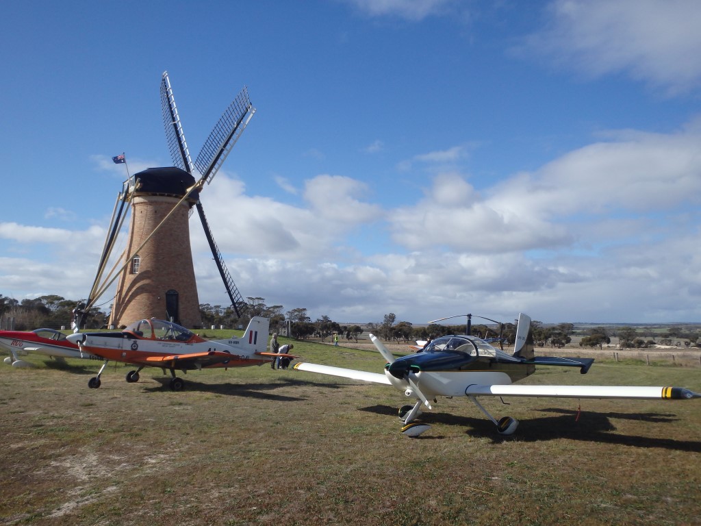 Aircraft on the ground nex to the mill.