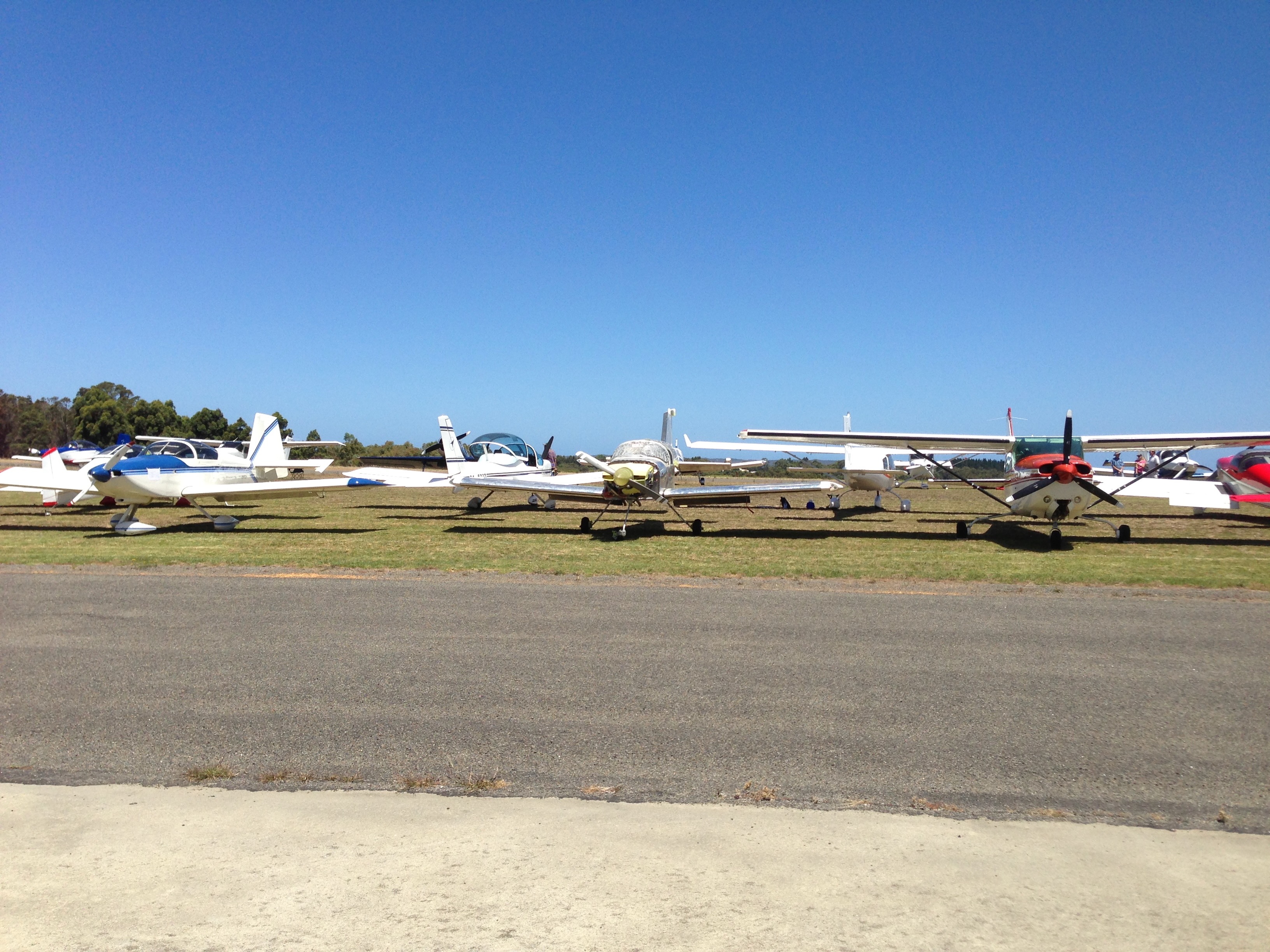 Stearman taxiing out past other aircraft